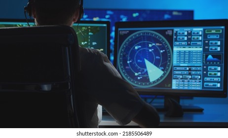 Workplace of the professional air traffic controller in the control tower. Caucasian aircraft control officer works using radar, computer navigation and digital maps. Aviation concept. - Shutterstock ID 2185506489
