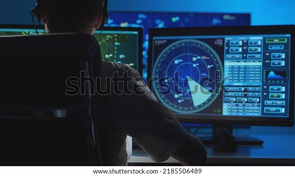 Workplace\
of the professional air traffic controller in the control tower.\
Caucasian aircraft control officer works using radar, computer\
navigation and digital maps. Aviation\
concept.