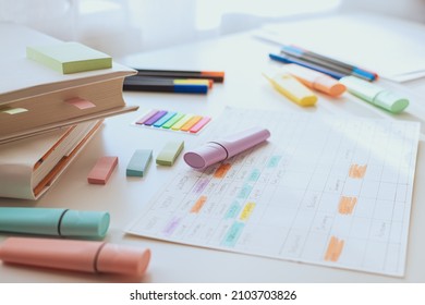 Workplace of a pupil or student. White study table with books and a weekly schedule. Side view. Selective focus. - Shutterstock ID 2103703826
