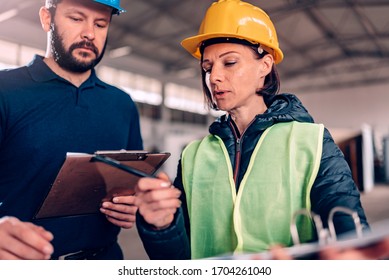 Workplace Safety Inspector Writing A Report At Industrial Factory