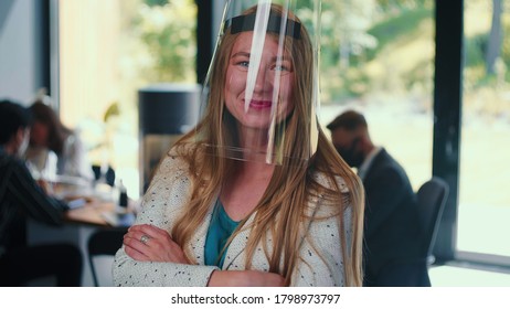 Workplace Safety Measures. Portrait Of Young Happy Business Woman Wearing Plastic Face Shield At Office Slow Motion.