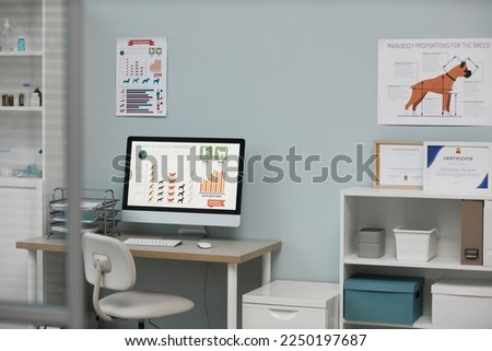 Workplace of vet expert with graphic information describing quantity of dogs most common breeds on screen of computer monitor