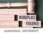 WORKPLACE VIOLENCE - words on wooden blocks on a white background with a judge