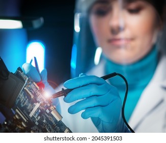 Workplace Of Young Woman In Modern Microelectronics Manufacturing Lab. Engineer Works In A Modern Scientific Laboratory On Computing Systems And Microprocessors.
