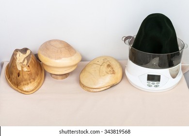 workshop for alpine felt hat making - few wooden hat-blocks made for shaping of felt hats and felt hood in vaporizer - Powered by Shutterstock