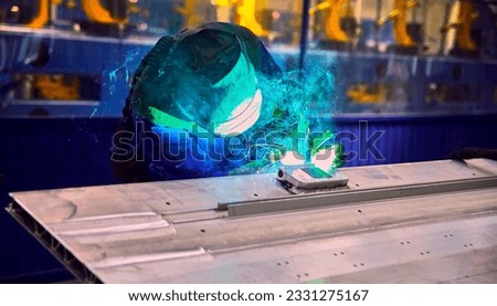 Workshop for assembling metal frames for subway cars, trams and trains. Welders assemble body parts.