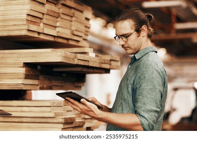 Workshop, carpenter and man with tablet for digital, research and information for wood checklist. Business, male person and supplier with technology for inventory management, reading and track order