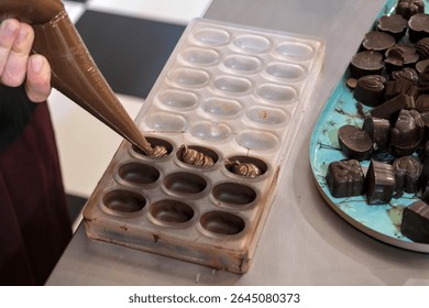 Workshop to create a chocolate plaque and filled chocolates. Poaching filled chocolates