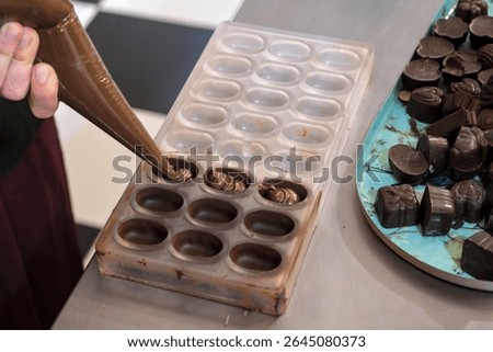 Workshop to create a chocolate plaque and filled chocolates. Poaching filled chocolates