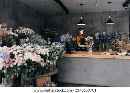 Workshop florist, making bouquets and flower arrangements. Woman collecting a bouquet of flowers. Soft focus. High quality photo