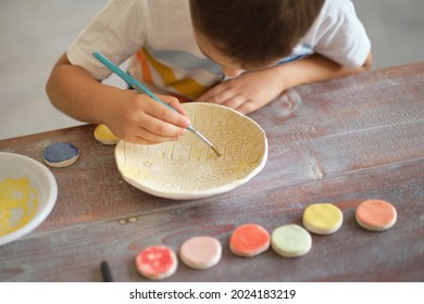 workshop for kids. Children learning how to use clay for making beautiful dishes. Workshop, master class. - Powered by Shutterstock