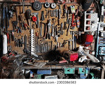 workshop scene with old tools hanging on wooden panel , vintage garage style background
