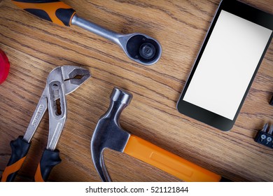 Workshop set  with smart phone. Tools on the table and board.
