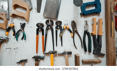 Workshop wall displaying various hand tools for craftsmanship and home improvement