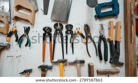 Workshop wall displaying various hand tools for craftsmanship and home improvement