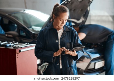 Workshop, woman or car mechanic with digital tablet, maintenance and search with confidence. Repair shop, female expert and technology for motor inspection, ecommerce and typing to order parts online - Powered by Shutterstock