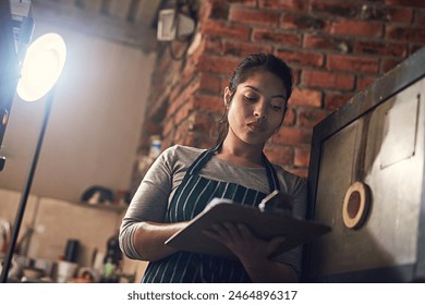 Workshop, woman and invoice checking with clipboard, paperwork and inventory with writing. Entrepreneur, planning and retail document for creative business and art studio by ceramic and pottery kiln - Powered by Shutterstock