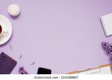 The workspace of a blogger or freelancer Flat lay with a cup of coffee, notebooks and lilac branches, stationery on a lilac background with a copy space - Powered by Shutterstock