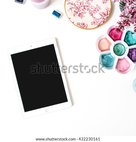 Workspace. Brushes, palette, bouquet of lilac, tablet  isolated on white background. flat lay, overhead view, top view