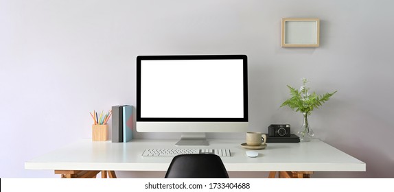 Workspace computer empty screen and creative office supply on work desk with photo frame. - Shutterstock ID 1733404688