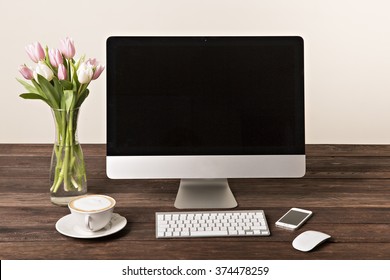 Workspace With Computer At Home Or In The Studio , A Desk With Flowers.