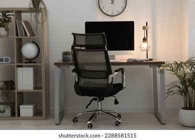 Workspace with desk, chair and computer at home