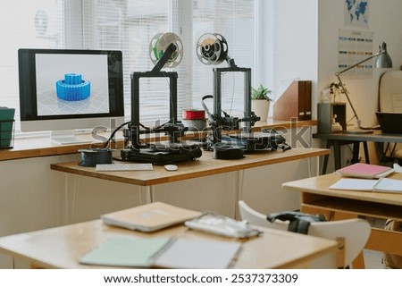 Workspace featuring multiple 3D printers actively creating intricate gears. Bright natural light streaming in through windows highlighting advanced technology