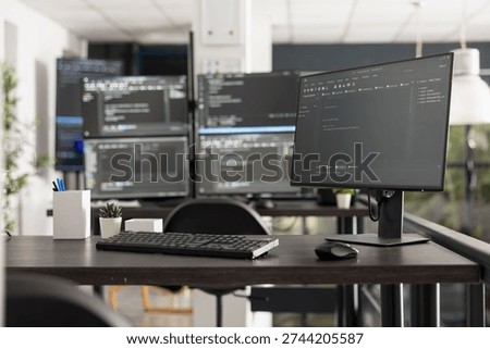 Workspace featuring multiple computer monitors displaying intricate programming code and algorithms, illustrating a developer environment for software engineering and data analysis.