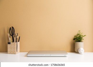 Workspace, Laptop Computer Closed, Marble Skull, Office Accessories And Wall With Copy Space.