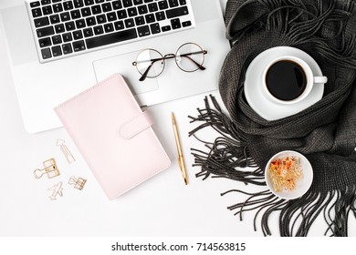 Workspace with laptop, planner, coffee cup wrapped in scarf, golden clips, glasses. Stylish office desk. Autumn or Winter concept.  Flat lay, top view - Powered by Shutterstock