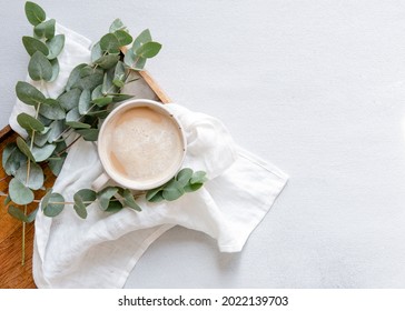 Workspace With Leaves Eucalyptus, Cup Of Coffee On White Background. Art Frame. Flat Lay, Overhead View, Home Workspace