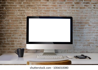Workspace mockup with desktop computer red brick wall and office supplies. blaink screen monitor for graphic display montage. - Shutterstock ID 1006010080