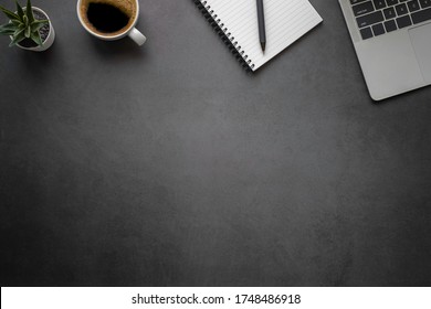 Workspace In Office With Black Table. Top View From Above Of Laptop With Notepad And Coffee. Desk For Modern Creative Work Of Designer. Flat Lay With Blank Copy Space. Business And Finance Concept.