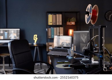 Workspace showcasing advanced 3D printer amidst contemporary office setting. Monitor displaying design software and various organizational tools highlighting productive environment