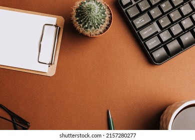 A workspace with stationery on a brown background. Concept: freelance, work from home. - Shutterstock ID 2157280277