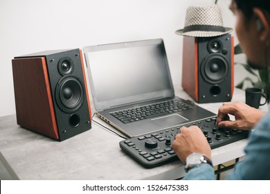 Workstation with speakers and computer in studio. Desktop in home office. Selective focus on the speaker.