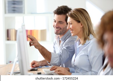 Workteam In Office Working On Desktop Computer