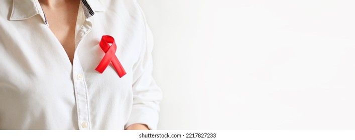 World AIDS And Hiv Day. Woman In White Shirt Holds Red Ribbon. Blood Transfusion And Donation. Hemophilia Day. World Cancer Day