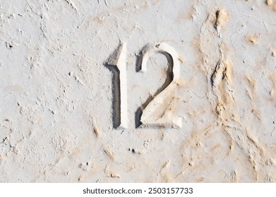 WORLD AMPERSAND DAY. World Statistics Day. National Numeracy Day. Close-up of the Number 12 Etched, Carved in Stone. Calendar Day 12. Estonia - Powered by Shutterstock