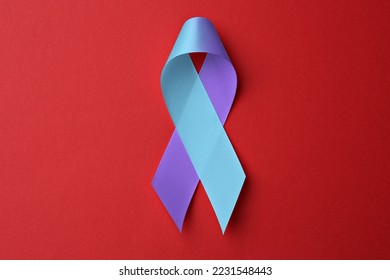 World Arthritis Day. Blue and purple awareness ribbon on red background, top view - Shutterstock ID 2231548443
