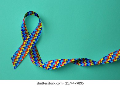 World Autism Awareness Day. Colorful Puzzle Ribbon On Cyan Background, Top View