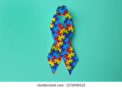 World Autism Awareness Day. Colorful Puzzle Ribbon On Cyan Background, Top View