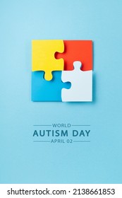 World Autism Awareness Day or month concept. Creative design for April 2. Color puzzle, symbol of awareness for autism spectrum disorder on blue background. Top view, copy space for text. 
