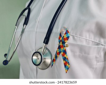 World Autism Awareness and Pride Day with ribbon with puzzle pattern. Autism causes symptoms of disease - Powered by Shutterstock