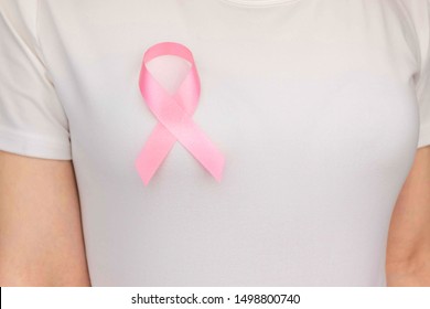 World Breast Cancer Day Concept,health care - woman wore white t-shirt,Pink ribbon for breast cancer awareness, symbolic bow color raising awareness on people living with women's breast tumor illness - Shutterstock ID 1498800740