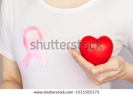 World Breast Cancer Day Concept,health care - woman wore white t-shirt,Pink ribbon for breast cancer awareness, symbolic bow color raising awareness on people living with women's breast tumor illness