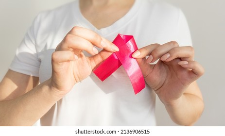 World Breast Cancer Day. A Woman In A White T-shirt Holds A Pink Ribbon In Her Hands As A Symbol Of Social Consciousness.
Prevention Of Breast Cancer. Manual Examination Of The Breast.woman Doing Manu