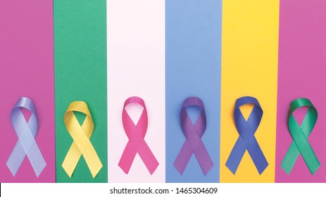 World Cancer Day Background. Colorful Ribbons, Cancer Awareness. Blue Surface From Above. CMYK Print Banner.