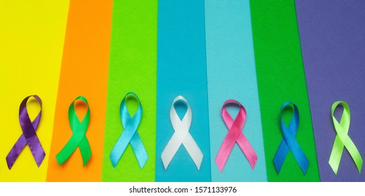 World Cancer Day February 4 Background. Colorful Ribbons, Cancer Awareness. Blue Surface From Above.