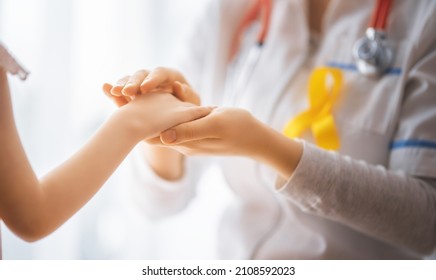 World Childhood cancer Day. Girl patient listening to a doctor in medical office. - Powered by Shutterstock